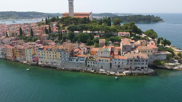 Aerial rotating shot of St. Euphemia church surrounded by medieval old town in Rovinj, Istria, Croat