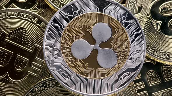 Ripple XRP coin on bitcoins background, cryptocurrency investing concept.