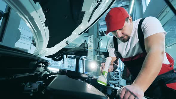 Close Up View of an Auto Mechanic Inspecting the Insides of a Car