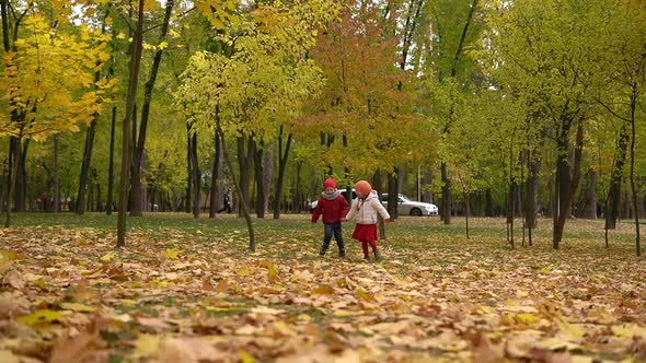 Two Happy Funny Children Kids Boy Girl Walking in Park Forest Enjoying Autumn Fall Nature Weather