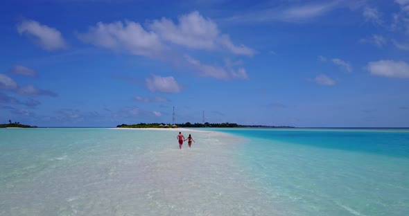 Young boy and girl after marriage in love spend quality time on beach on sunny white sandy backgroun