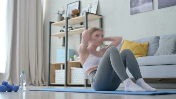 Athletic Young Woman Doing Crunches Exercise on Yoga Mat