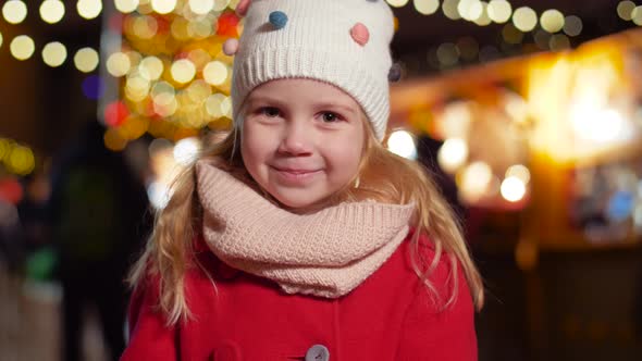 Portrait of Happy Little Girl at Christmas Market 