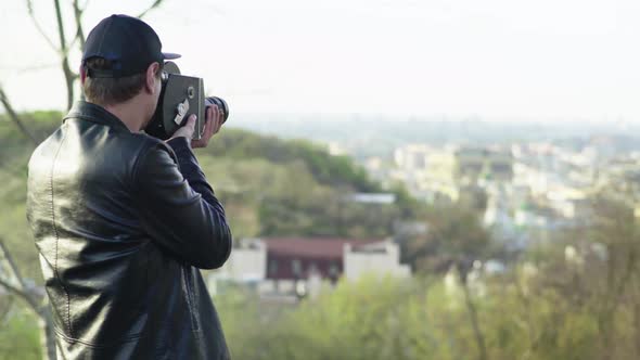 A Male Cameraman Shoots Video on an Old Vintage Camera Krasnogorsk. Kyiv. Ukraine