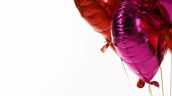 Red and purple balloons floating in the air 4k