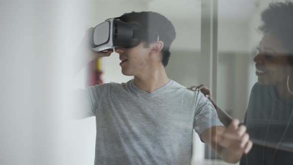 Teenage student wearing virtual reality glasses