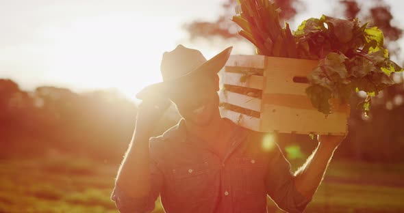 Portrait of farmer holding his harvest