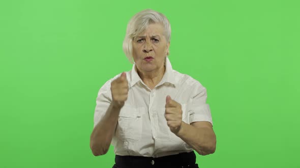 An Elderly Woman Quarrels at Someone. Old Grandmother. Chroma Key