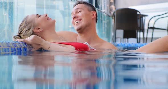 Young Woman with Fair Hair Bun in Pool Water By Coach