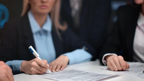 Closeup Handshaking of Business People Signing Contract Making Deal Partnership at Formal Meeting