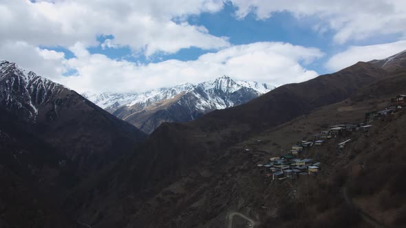 Amazing Mountain Landscape with Snow Peaks in Clouds