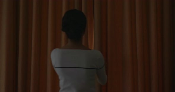 Woman open the curtain