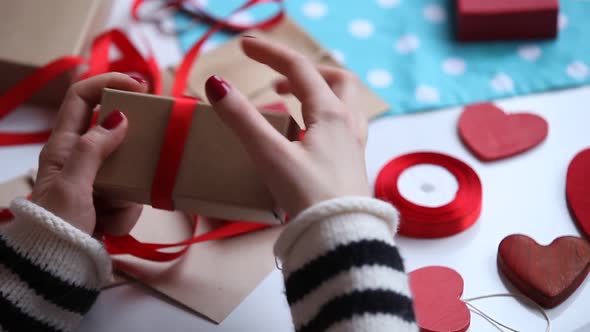 Female preparing for wrapping gifts on Valentine Day