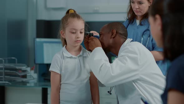 Doctor Doing Otology Examination with Otoscope to See Ear Infection