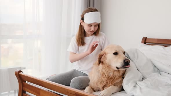 Girl with Golden Retriever Dog in the Bed