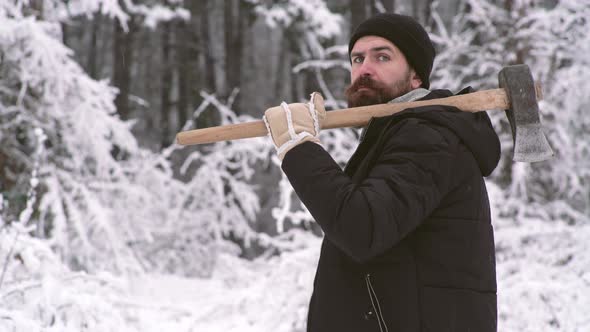 Lumberjack Man with Axe Carries a Tree