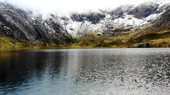 Sweeping near water in lake at Cwm Idwal, Snowdonia National Park, Wales, UK.