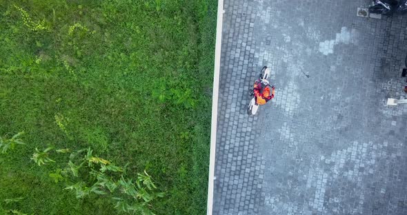 Aerial drone view of a man riding his motocross motorcycle