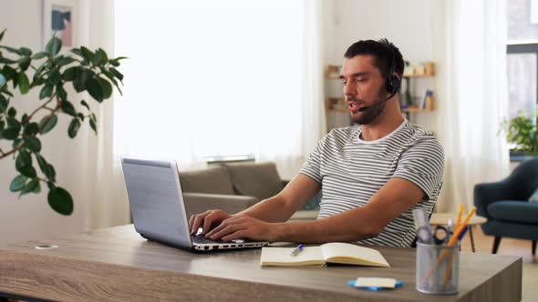 Man with Headset and Laptop Working at Home
