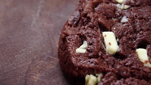 Slice of chocolate brownie on a wooden table. Brown cupcake with nuts. Sweet cake. Macro