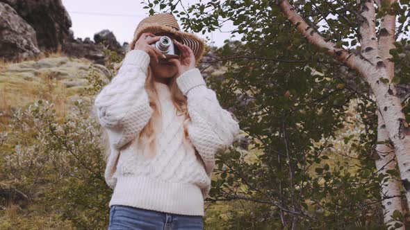 Blond Woman Photographing With Vintage Camera