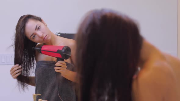 Woman Drying Her Hair After Getting Out Of Shower