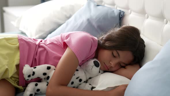 Soundly Sleeping Kid Hugging Toy in Bedroom Dreaming