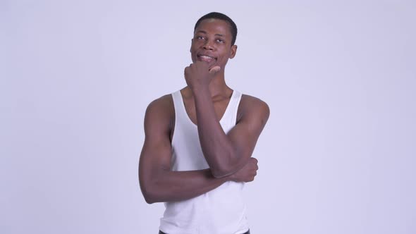 Young Happy African Man Thinking and Looking Up