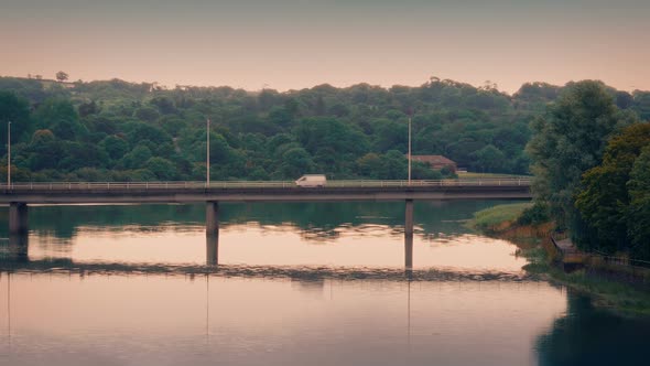 Cars Pass On Bridge At Sunrise