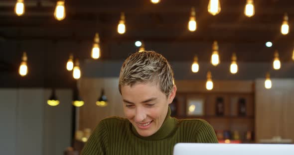 Executive using mobile phone in office cafeteria 