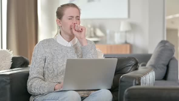 Attractive Woman with Laptop Coughing at Home