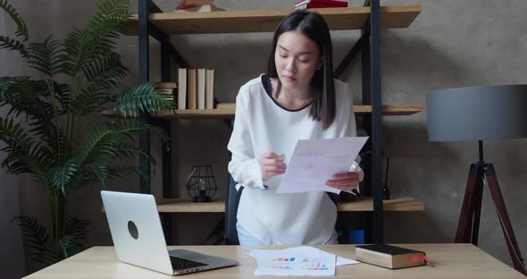 Young Asian Business Woman Working with Laptop and Papers Busy Woman Paying for Finances Checking