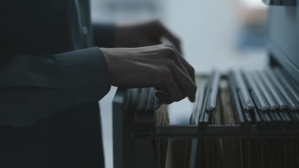 Clerk searching for a file in the cabinet