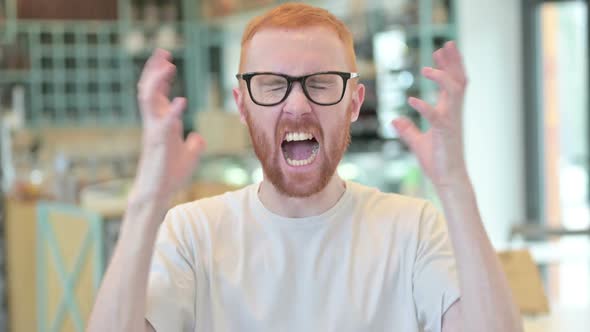 Portrait of Aggressive Redhead Man Shouting