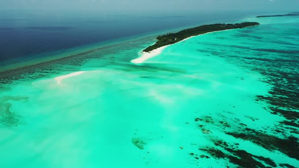 Aerial flying over scenery of marine shore beach time by blue green lagoon with white sand backgroun