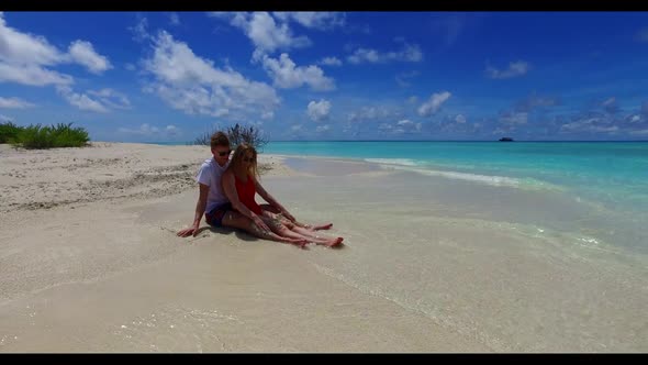Man and lady in love on marine shore beach time by turquoise ocean with white sand background of the