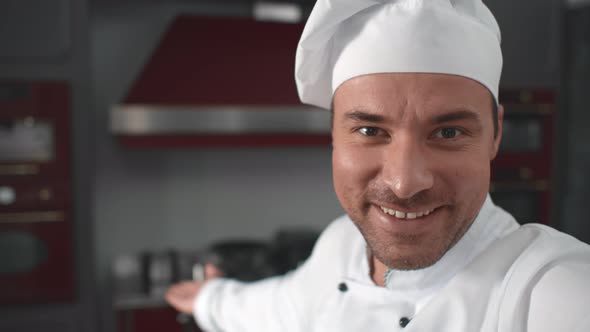 Happy Male Chef Filming Video Showing New Professional Kitchen To Followers in Internet Blog