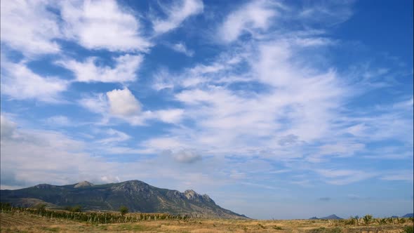 Mountains Against the Blue Sky with White Clouds. Cirrus Clouds Run Across the Blue Sky. Best Types