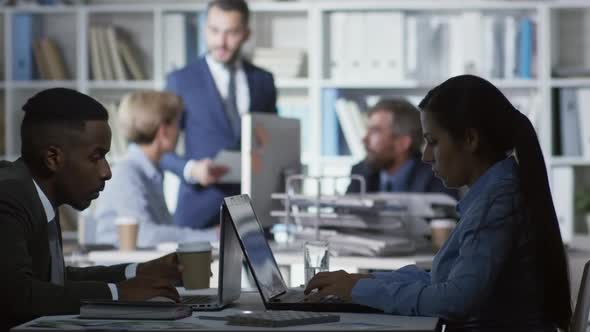 Office Workers Using Laptop Computers