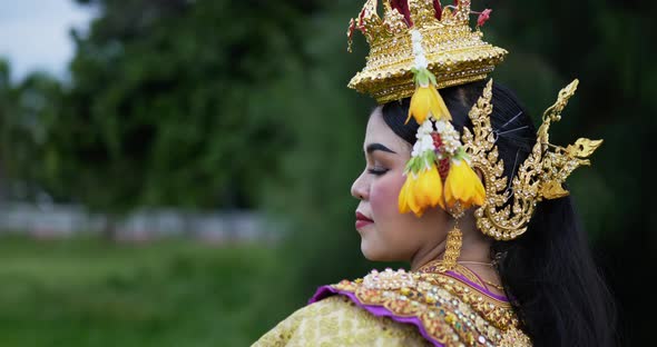 Thai woman in traditional dress looking at camera