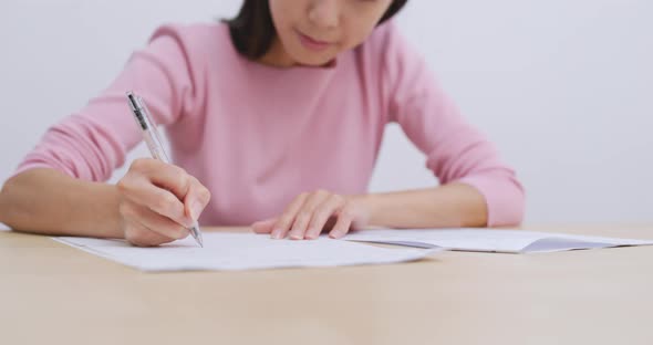 Woman doing revision on her note, study for exam