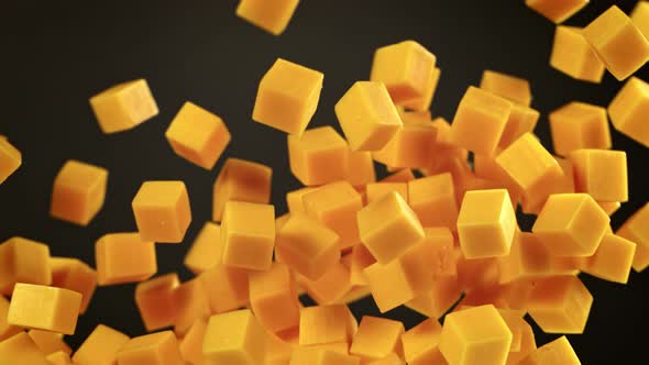 Super Slow Motion Shot of Flying Cheese Cubes on Black Background at 1000 Fps