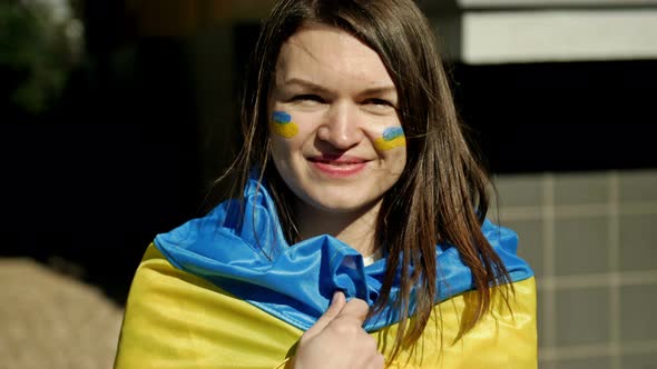 Portrait of a Woman with a Ukrainian Flag on His Shoulders