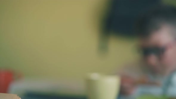 Motion Past Boy with Book and Child Eating Pizza at Table