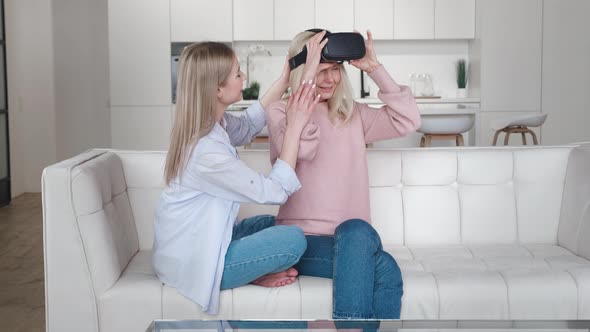 Adult Daughter Showing To Her Older Mother Using New Technology To Exploring the Virtual World