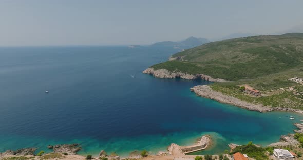 aerial view of rocky coast beach with blue water