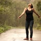 Slow Motion of a Young Happy Woman Dancing in the Summer Rain on a Road in the Forest. - VideoHive Item for Sale
