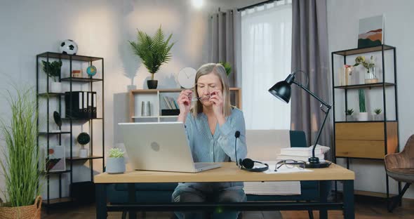 Stylish Middle Aged Woman Using Modern Laptop at Home