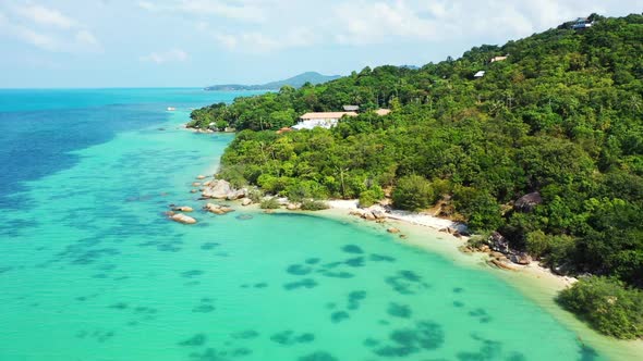 Aerial flying over texture of luxury lagoon beach lifestyle by blue ocean with white sandy backgroun