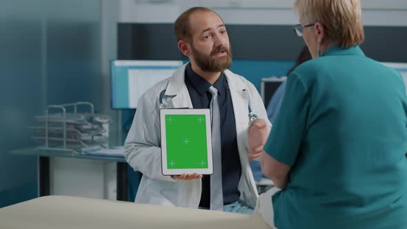 General Practitioner Using Digital Tablet with Green Screen